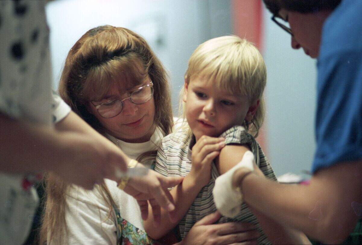 In August 1995, Kelly Bronson held Kyle Bronson while he received a vaccine at the Ridgmar Mall.